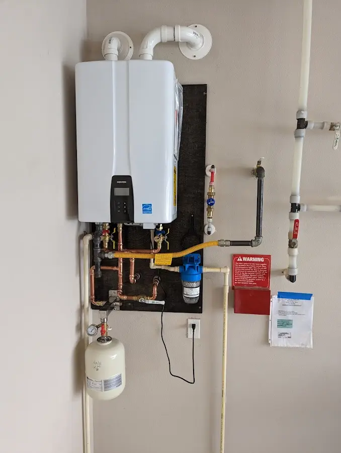 Professional plumber installing copper piping in a Moose Lake home